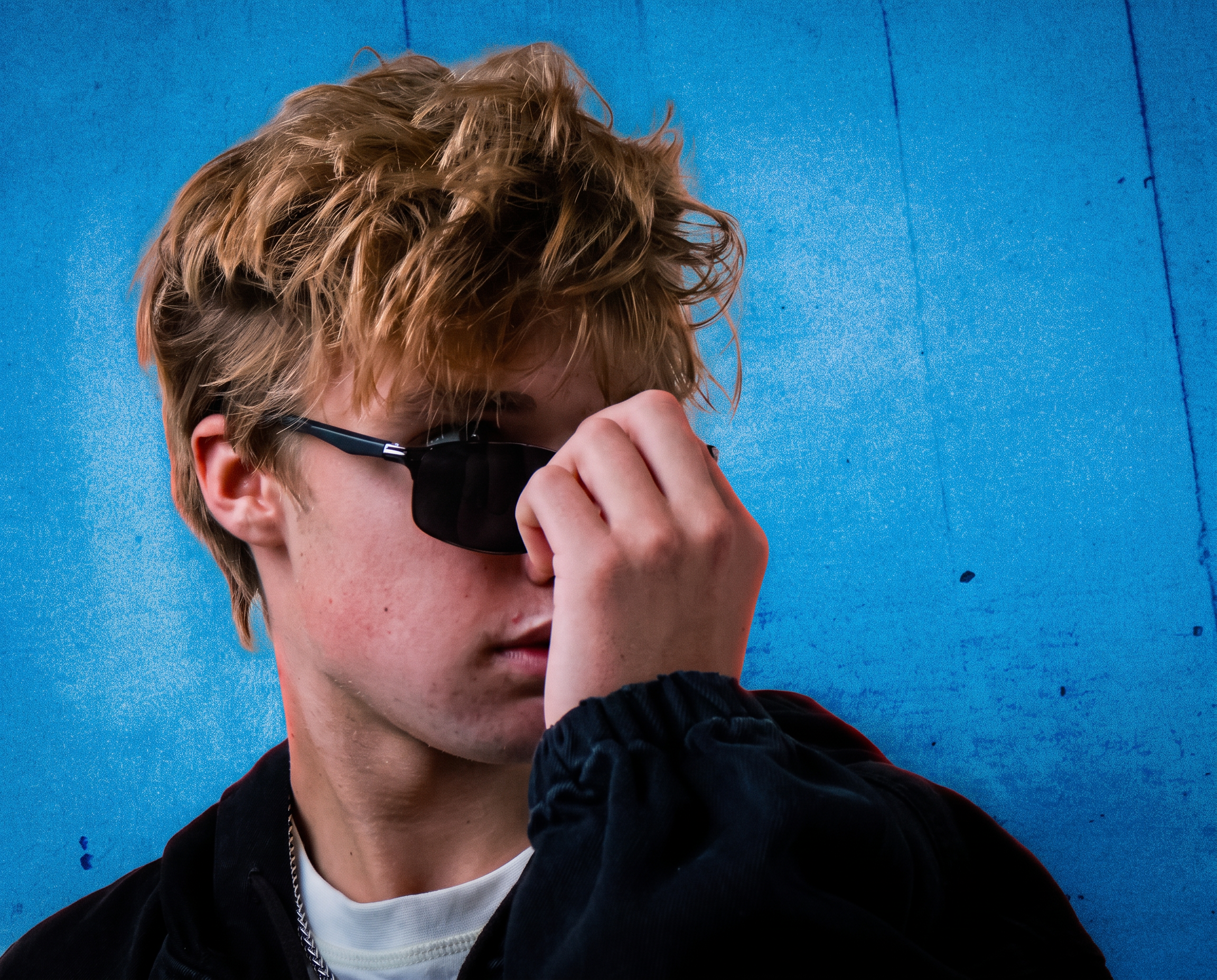 Portrait of It'z 1uk3 against an electric blue wall