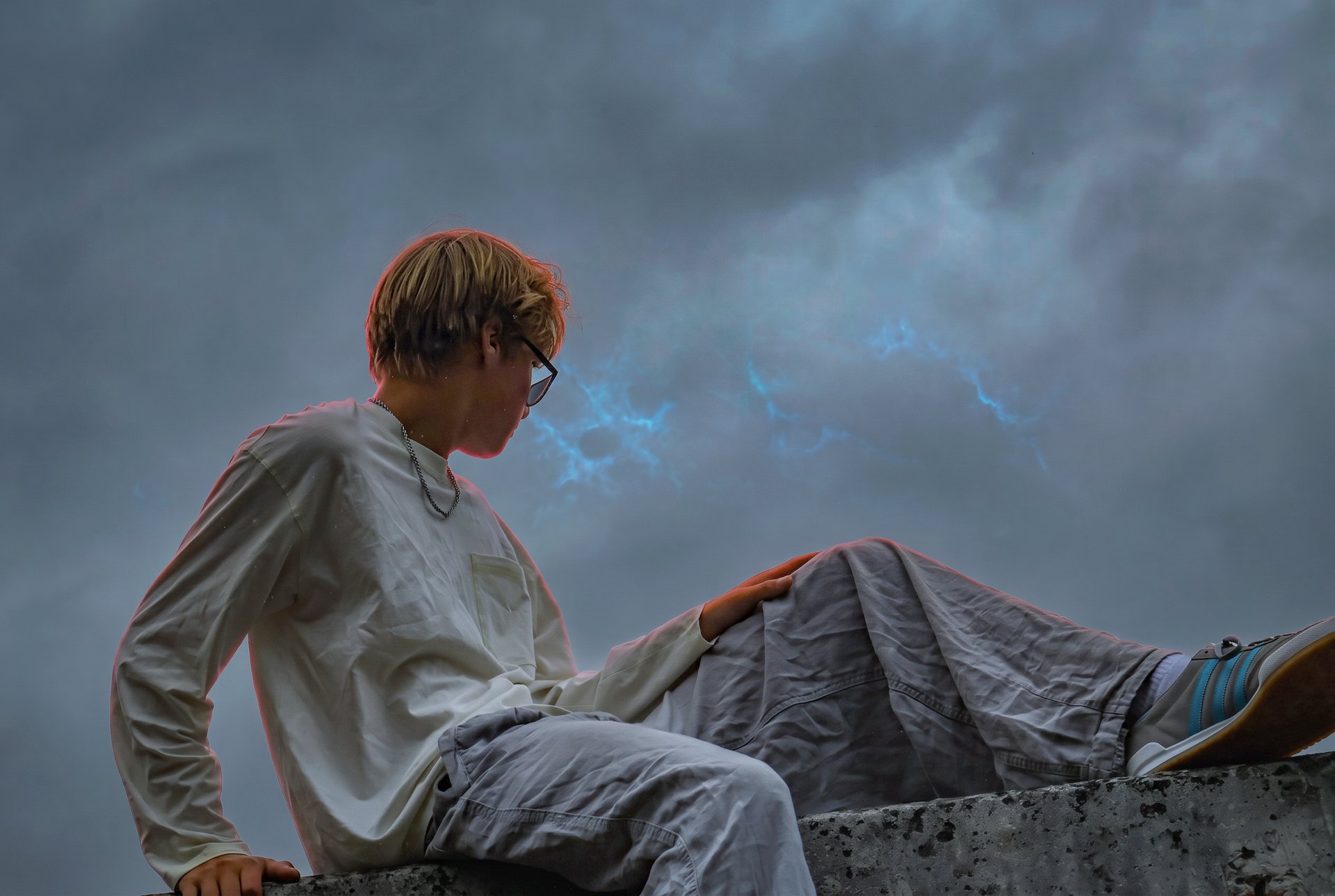 It'z 1uk3 seated against a dramatic dark sky